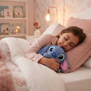 A child sleeping peacefully while hugging a soft blue breathing Stitch plush toy in a cozy, blush-toned bedroom.